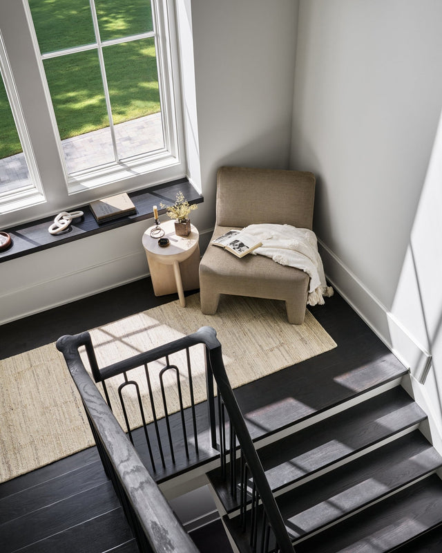 Handmade area rug in light beige with a subtle distressed geometric pattern