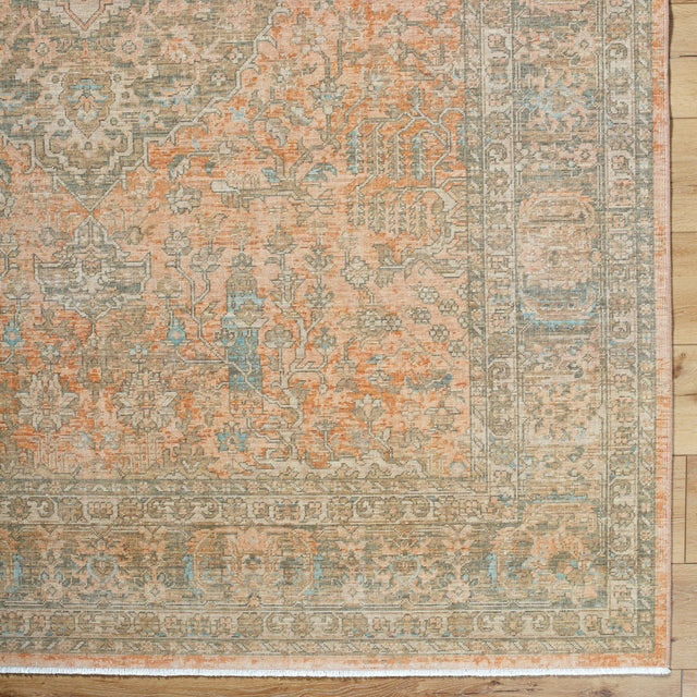 Handmade rug with distressed geometric pattern, beige center, teal accents, rust border