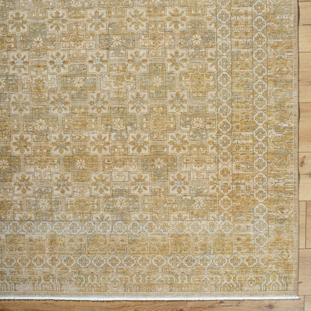 Handmade area rug with ornate geometric pattern in gold, beige, and ivory.