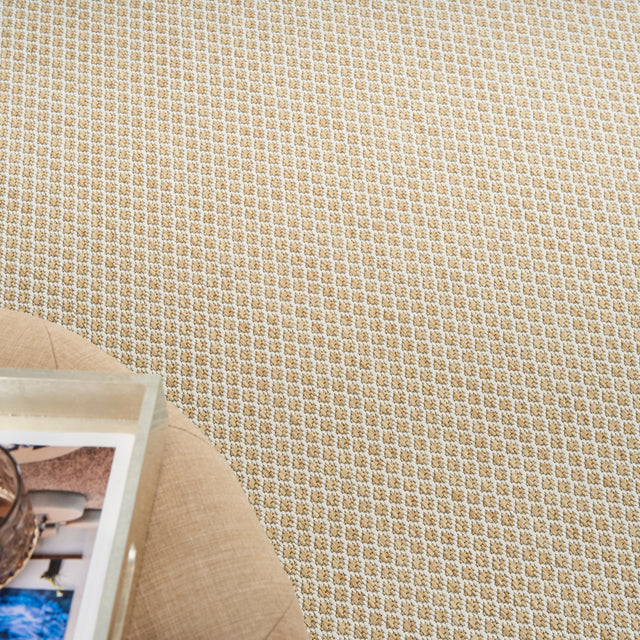 Corner close-up of natural lattice woven rug with tan border and dense texture