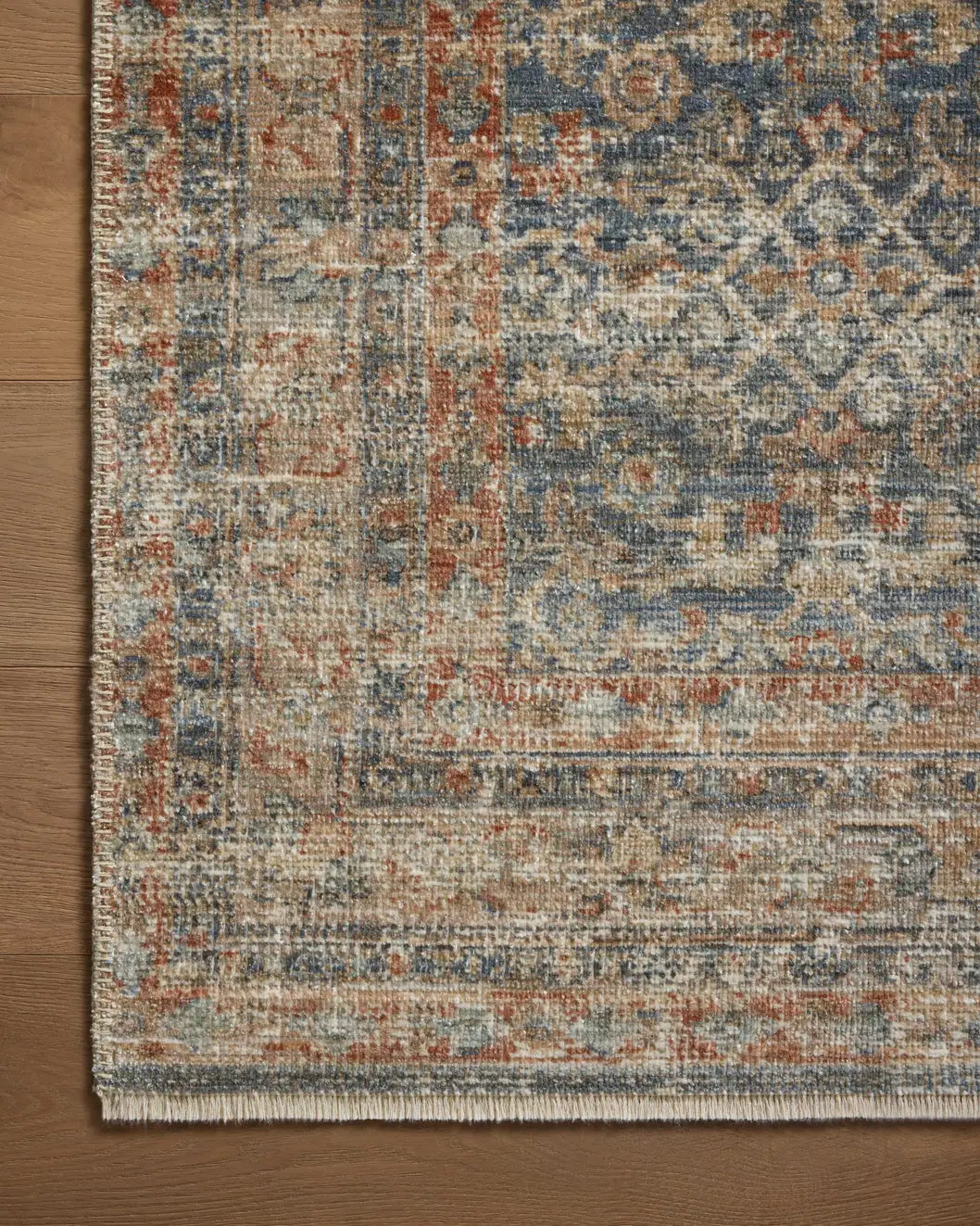 Loloi Heritage Her-12 Blue/Rust Rug - corner on wood