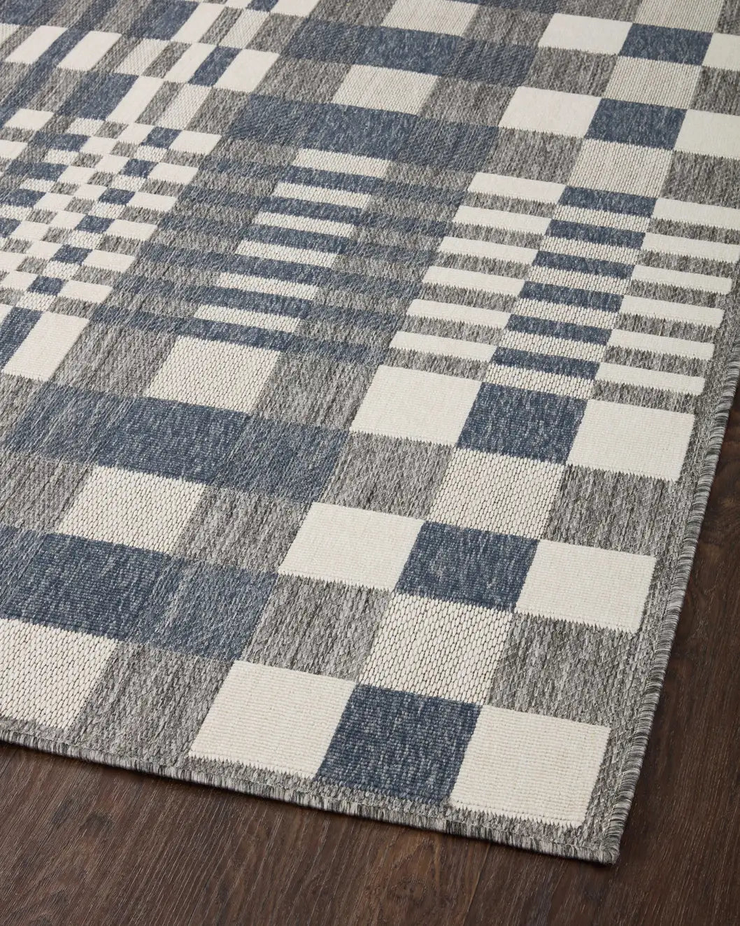 Loloi Rainier Rai-04 Ivory/Denim Rug - angled corner on wood