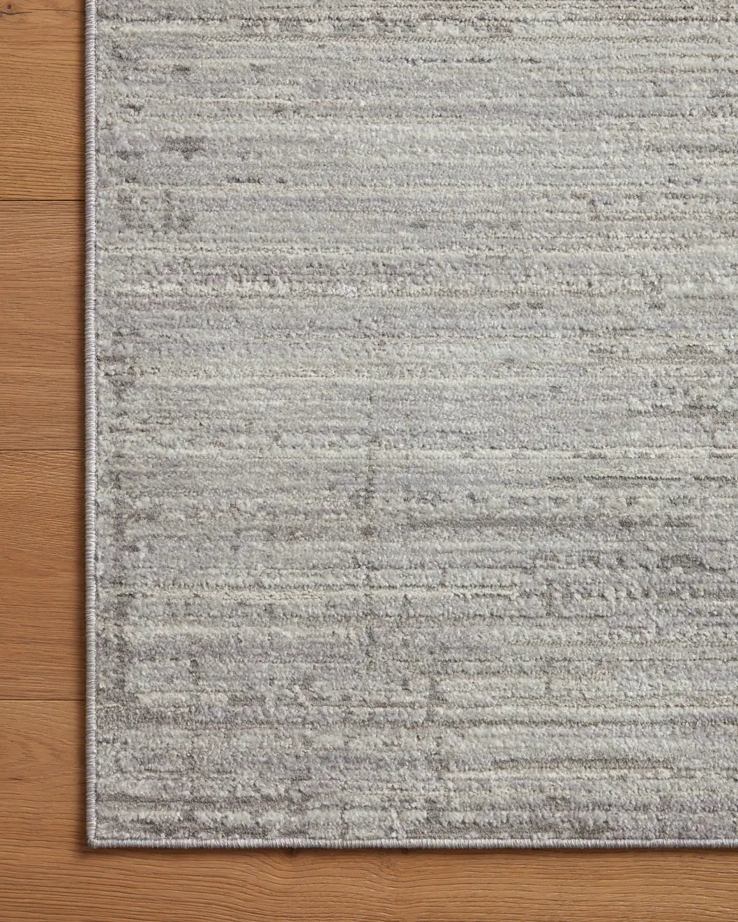 Loloi Arden Ard-02 Silver/Grey Rug - corner on wood