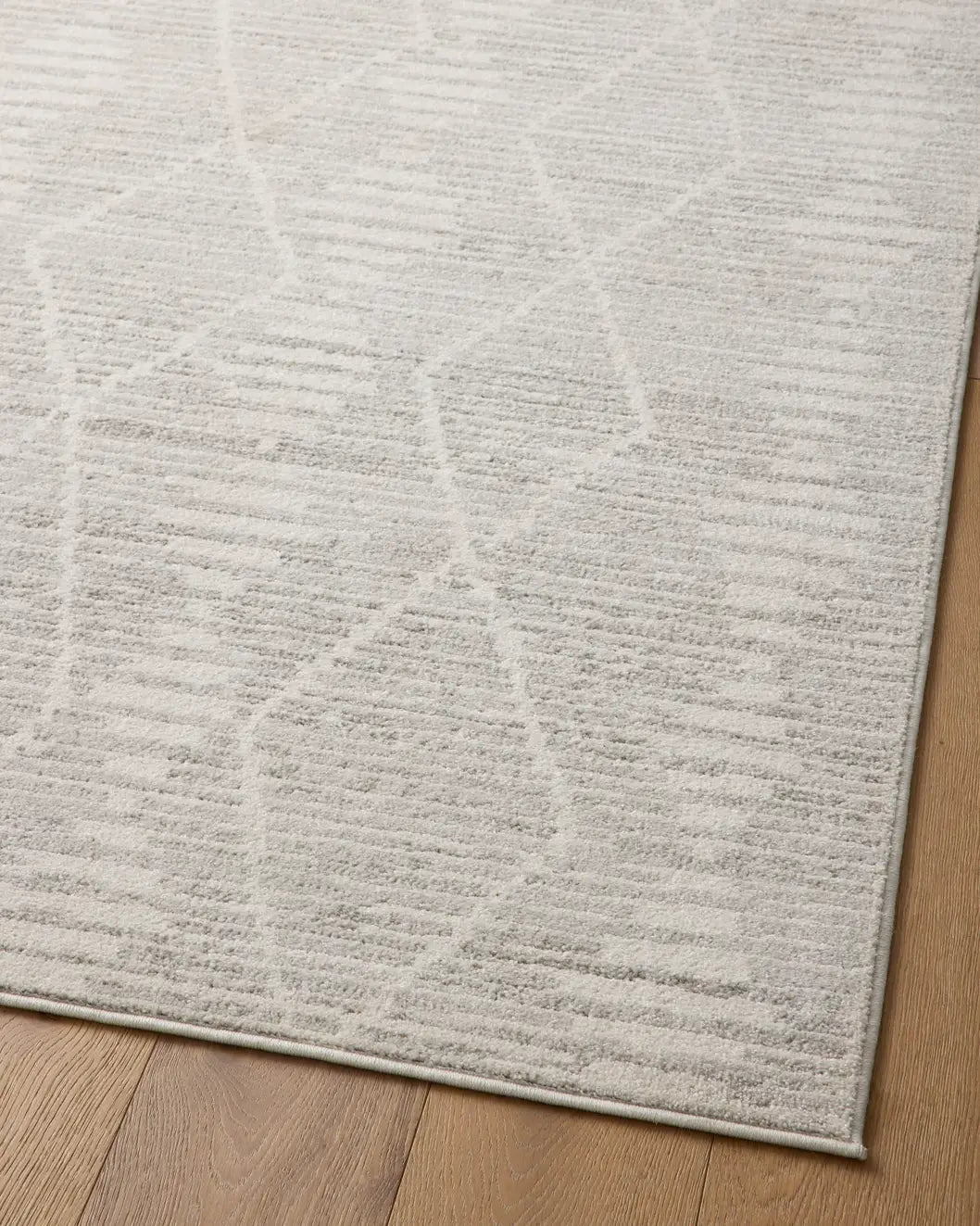 Loloi Kamala Kam-02 Ivory/Silver Rug - angled corner on wood