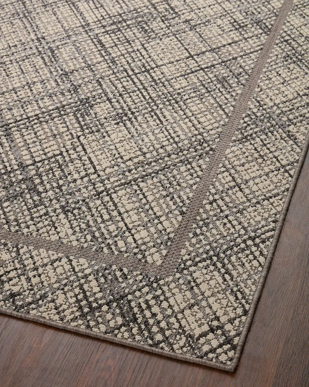 Loloi Rainier Rai-10 Ivory/Charcoal Rug - angled corner on wood