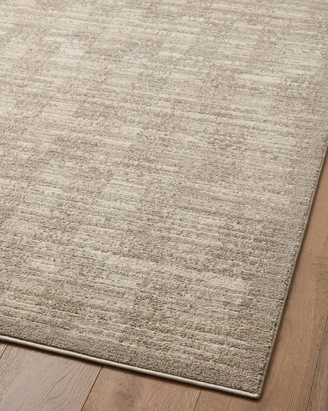 Loloi Darby Dar-07 Pebble/Sand Rug - angled corner on wood