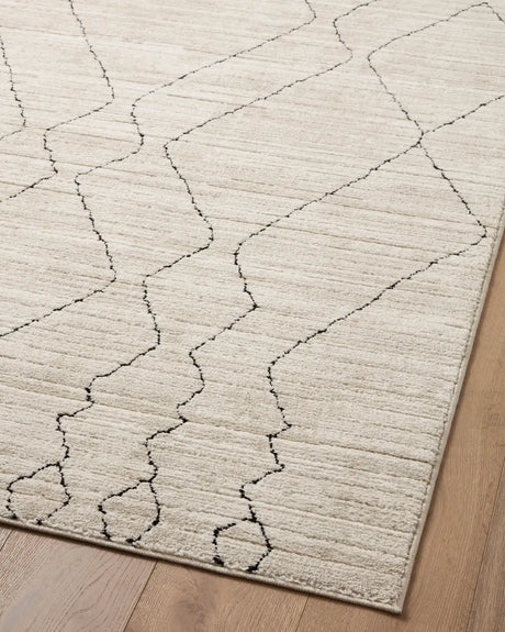 Loloi Darby Dar-03 Sand/Charcoal Rug - angled corner on wood