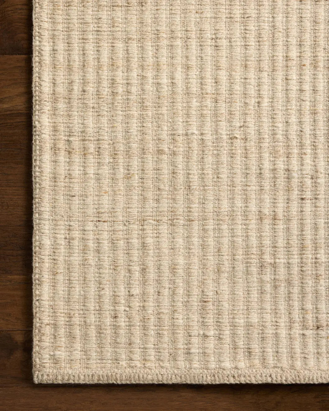 Loloi Elma ELM-01 Contemporary Hand Woven Bone Rug - corner on wood