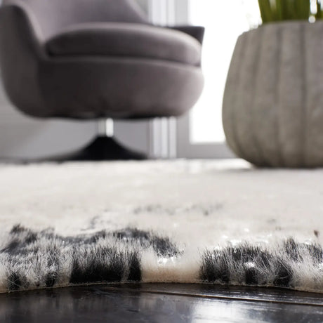 Safavieh Faux Cowhide 5'-0" x 6'-5" Rug in Beige / Black