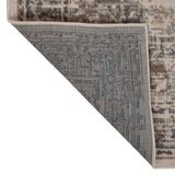 Rectangle area rug corner showing blue-gray border panel with beige backing fabric.
