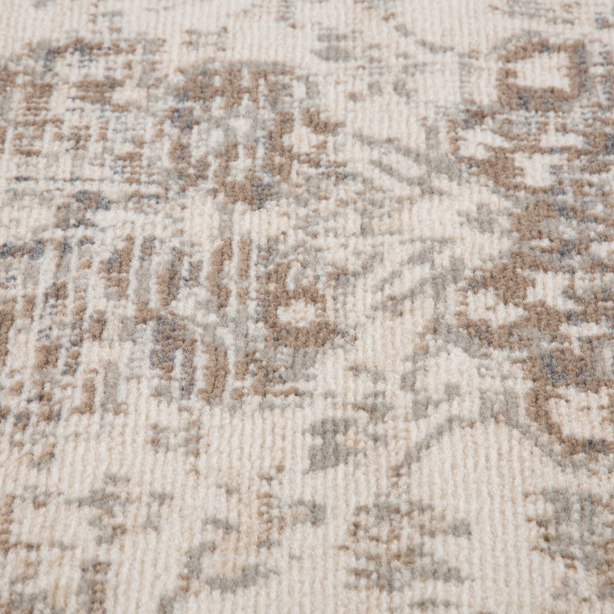 Light beige rug with distressed geometric medallion shapes in blue-gray, tight close-up.
