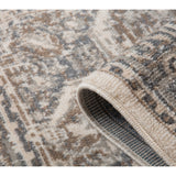 Rug corner in light beige with blue-gray motif lines and textured bound border close-up.