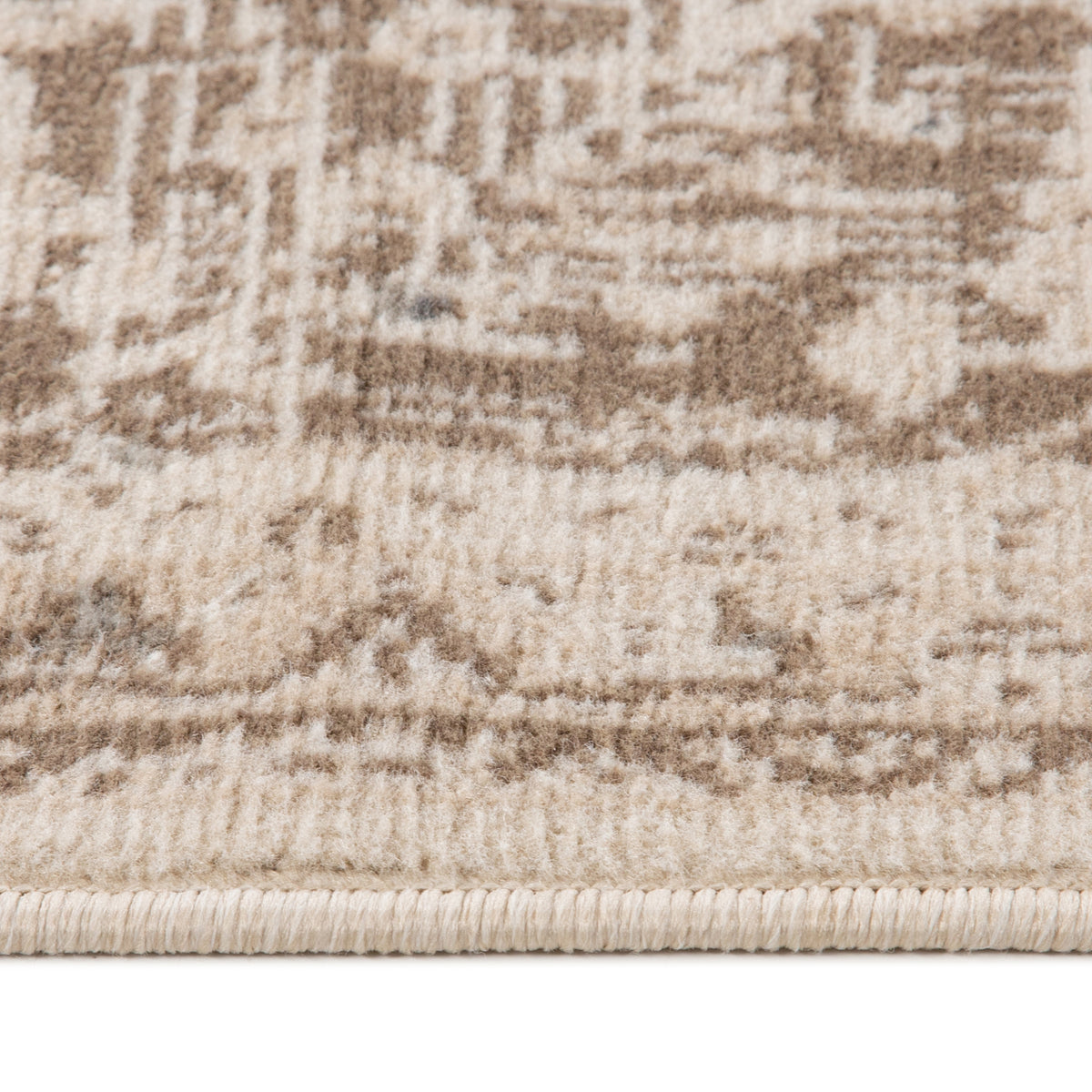Rug surface close-up showing light cream and taupe horizontal motif details and pile texture.