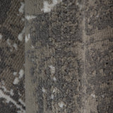Textured rug section in dark and light gray with dense pile and distressed look.