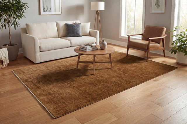 Rust-brown rectangular traditional area rug with subtle border and dense pile