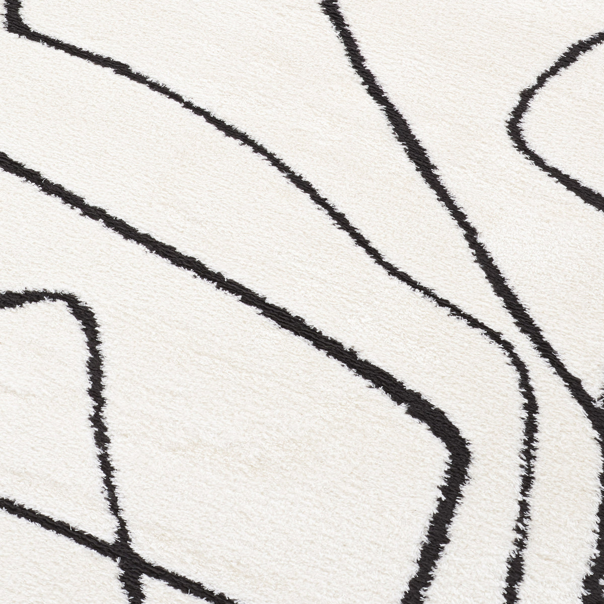 Close-up of ivory area rug with black contour lines forming angular shapes