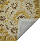 Folded floral area rug with beige fabric, gold detailing, and stitched border