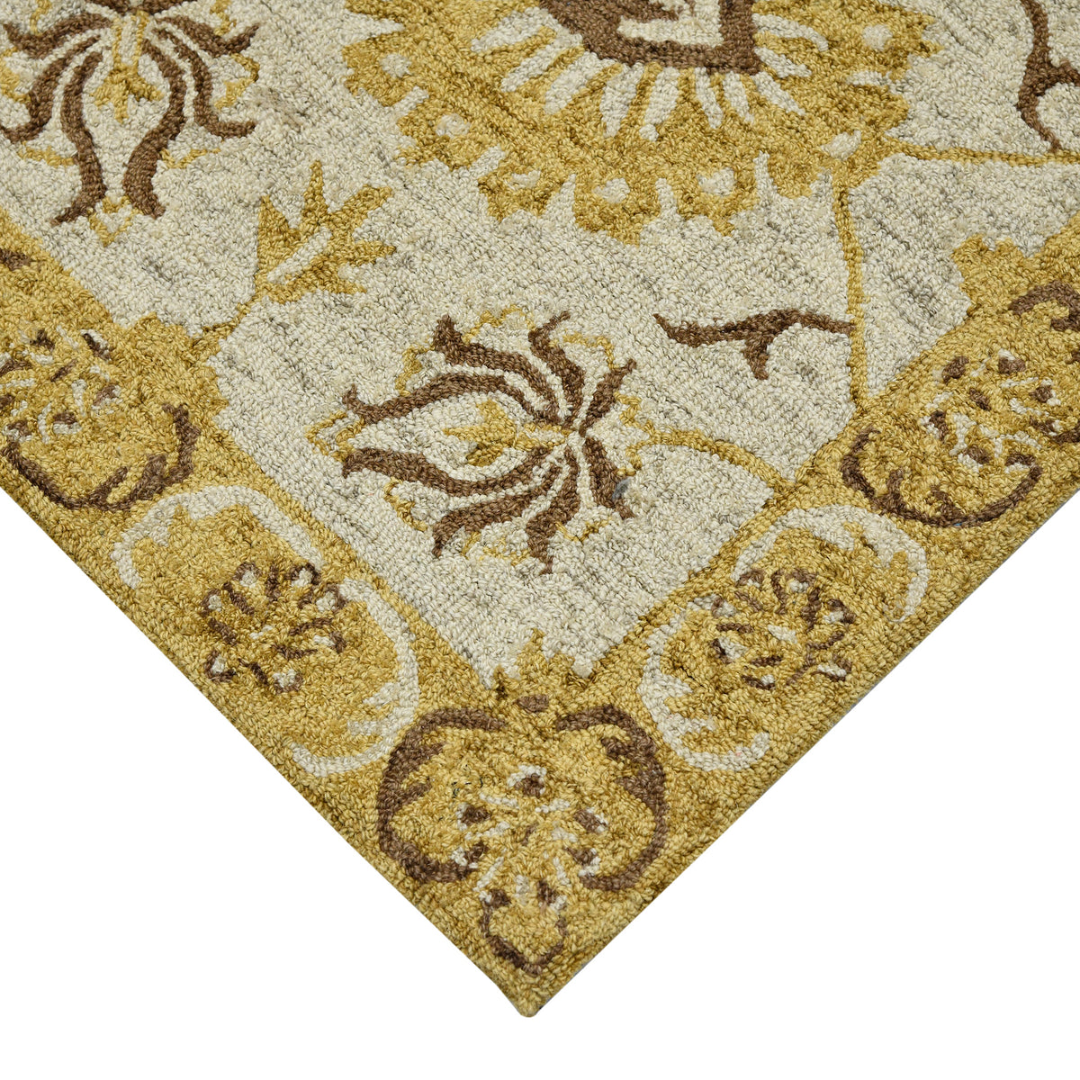 Diamond-shaped corner of floral area rug with beige ground and gold-brown medallions