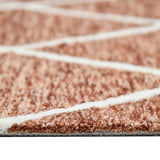 Hand-hooked rust area rug with cream geometric lines and short textured pile