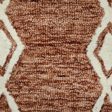 Textured rust geometric rug with cream background and interlocking diamond lines
