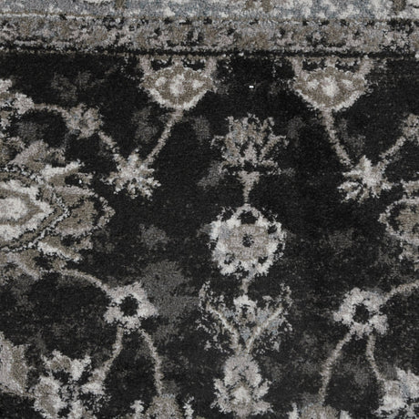 Black and ivory distressed geometric area rug pattern in close view