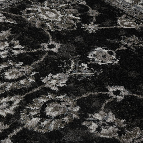 Black and ivory patterned area rug with distressed geometric motifs