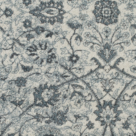 Close-up of light blue floral area rug with dense dark motif detailing