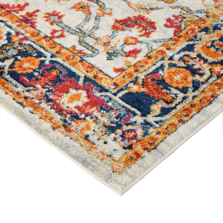 Corner of ivory area rug with multicolor ornamental border and distressed pattern.