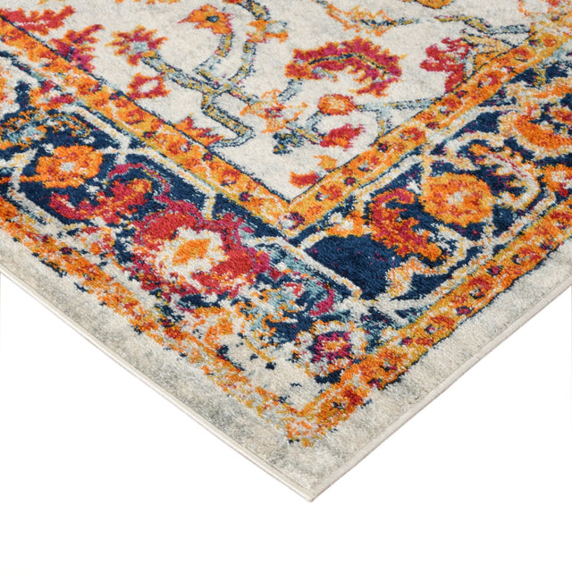 Corner of ivory area rug with multicolor ornamental border and distressed pattern.