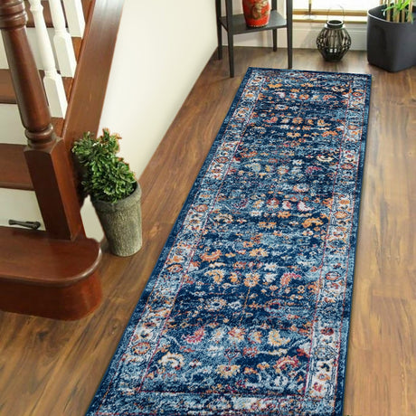 Rectangular navy distressed area rug with ornate border and patterned center