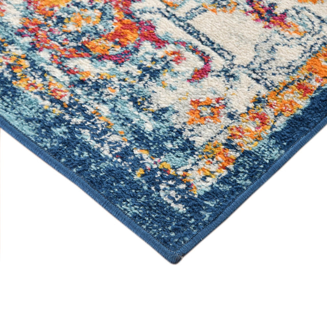 Navy bordered area rug with distressed floral medallion pattern, short pile edge