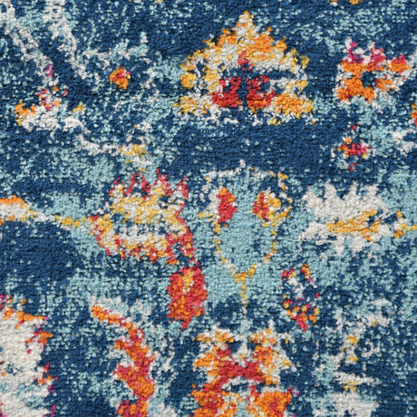 Navy short-pile area rug with multicolor distressed floral and speckled pattern
