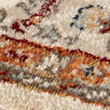 Ivory area rug with dense multicolor abstract pattern in blue, orange, and red tones