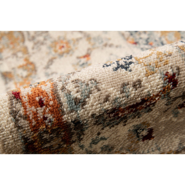 Ivory multi-color area rug with textured low pile and abstract motifs along the border