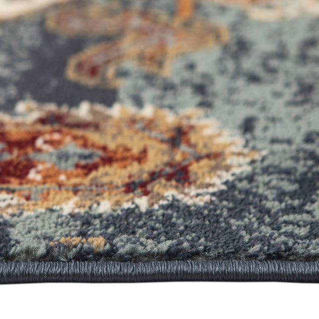 Teal blue area rug border with dense low pile and multicolor distressed pattern