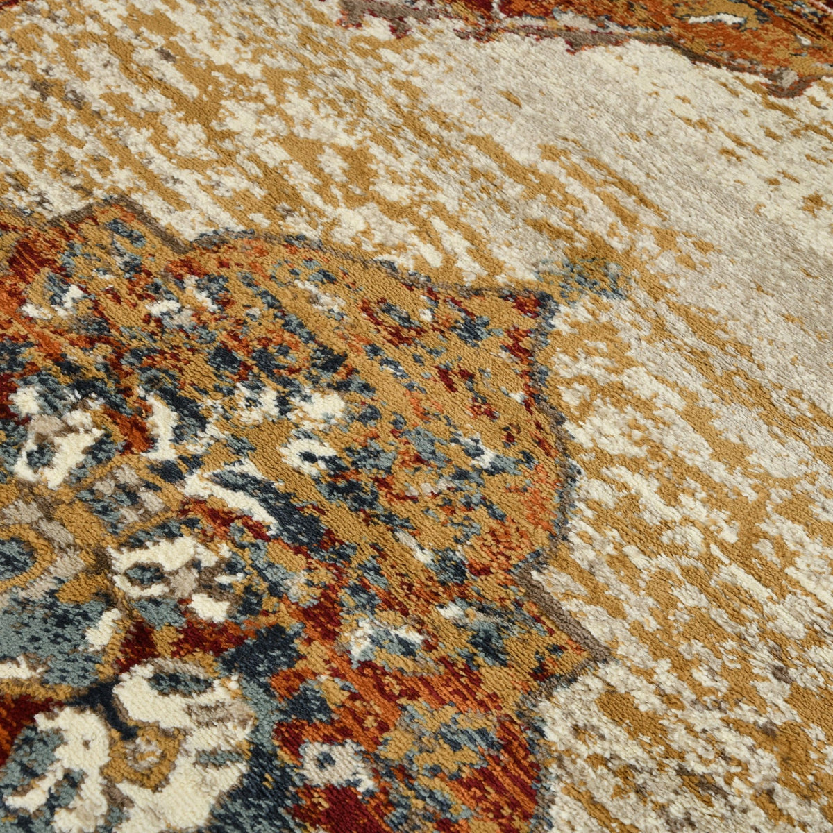 Multicolor distressed area rug section with beige ground and floral medallion motifs.