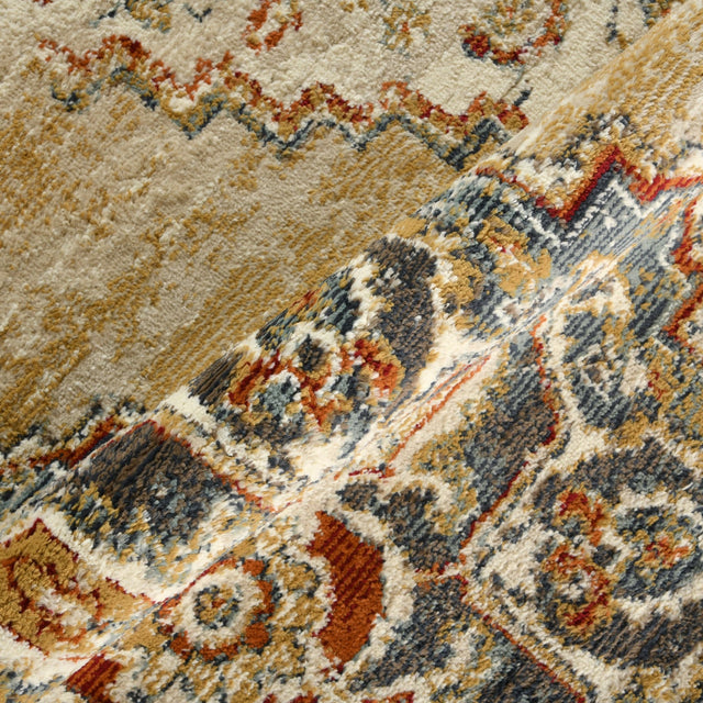 Rectangle area rug textured surface with beige base and blue, rust, and gold detailing