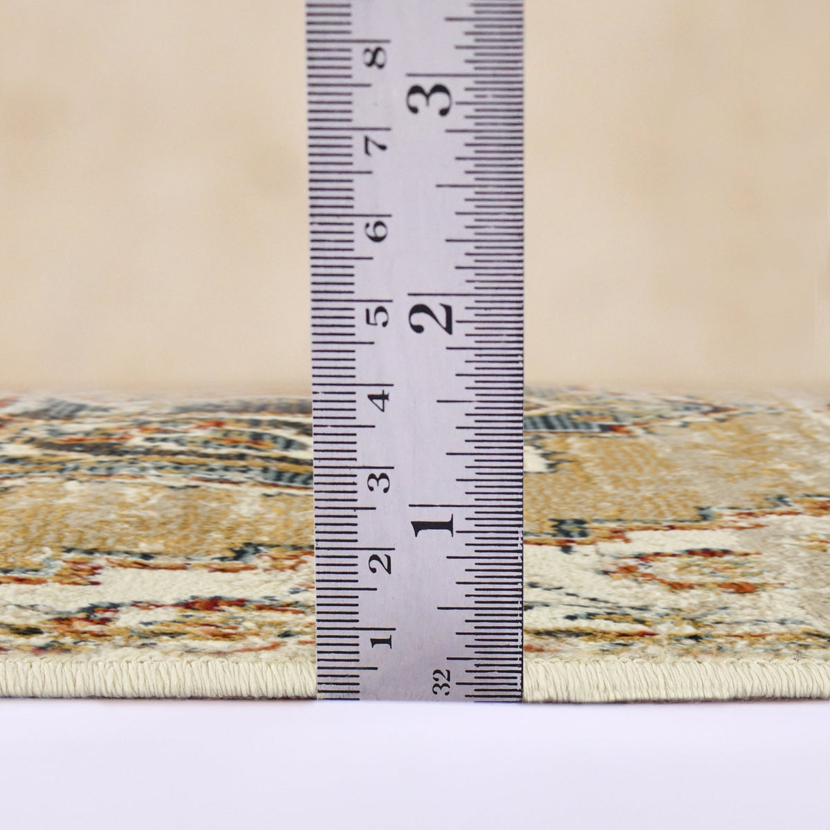 Low pile rectangle area rug with beige and multicolor pattern, edge measurement