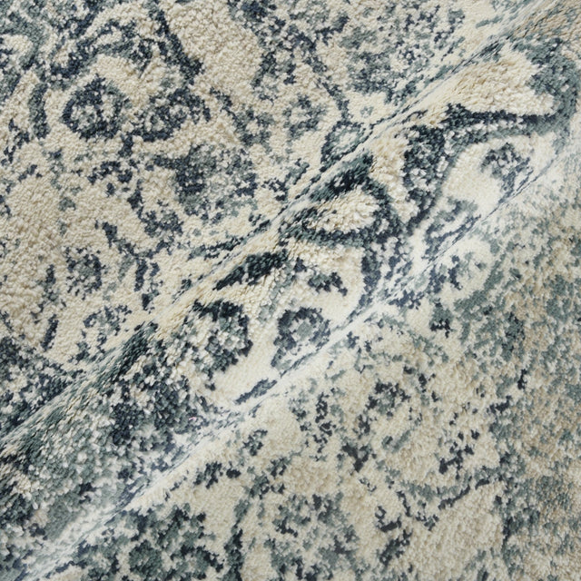 Blue and ivory area rug close-up texture with distressed floral medallion