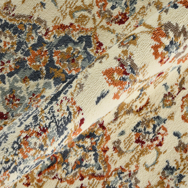 Ivory area rug section with dense medallion and floral pattern in navy and orange