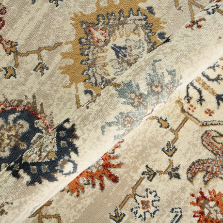 Beige oriental area rug close-up with faded blue, rust, and navy motifs