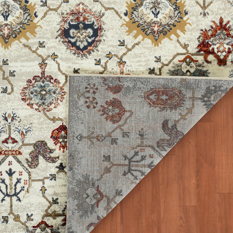 Beige oriental area rug corner showing reverse side with muted blue pattern