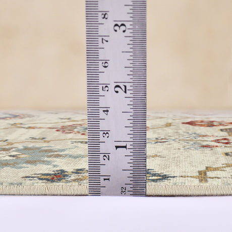 Beige oriental area rug with border and fringe; measured pile height