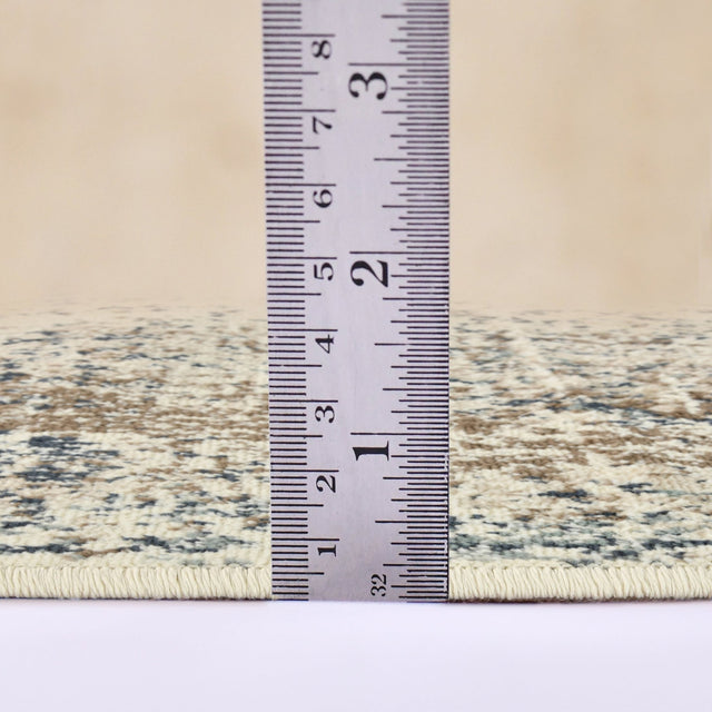 Area rug with low-profile border; tape measure shows short pile height