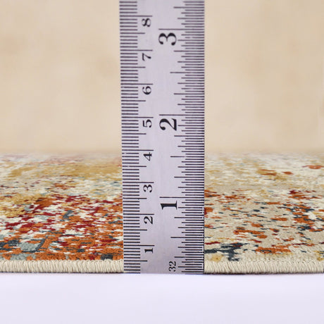 Area rug edge with measuring ruler across ivory and orange distressed pattern