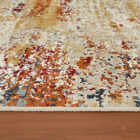 Close-up of ivory rug surface with rust-orange, blue, and cream abstract motifs