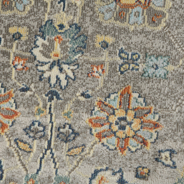 Gray bohemian floral rug with large orange and blue flower motif, detailed texture