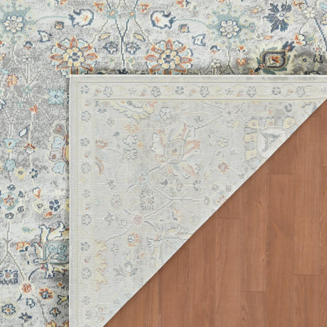 Gray bohemian floral area rug with multicolor medallion border, corner view