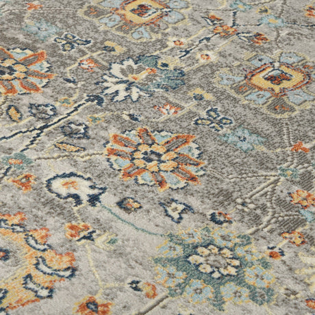 Gray bohemian floral area rug with ornate multicolor motifs, textured pile close-up
