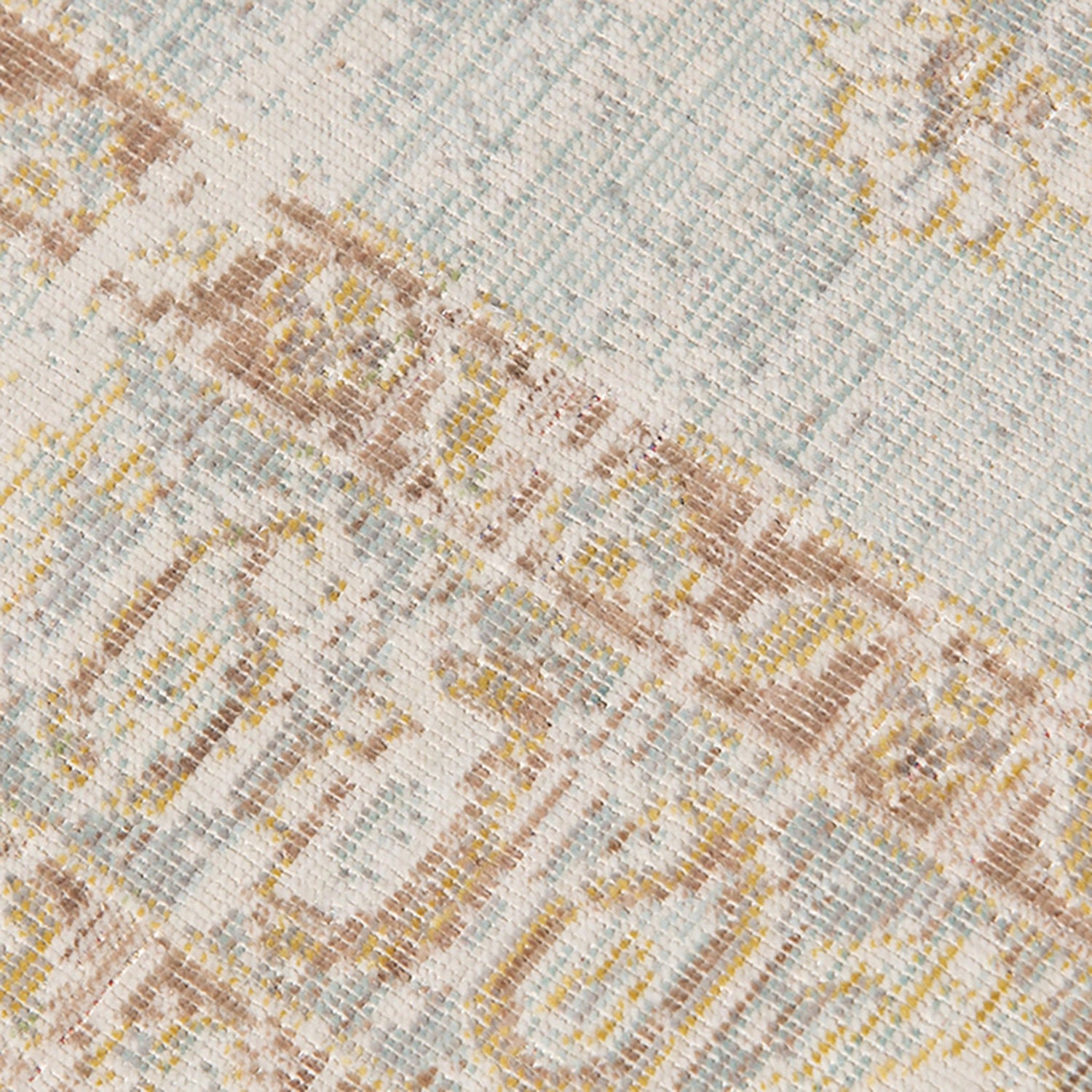 Close-up woven rug surface with diamond and stripe texture in ivory, gray, and tan